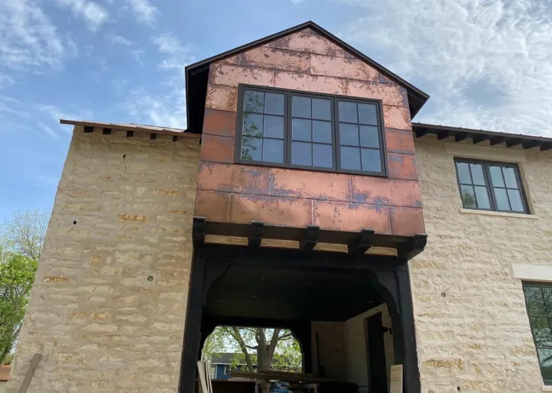 Copper metal panel facade on a stone building for Roof Repair in Nitro