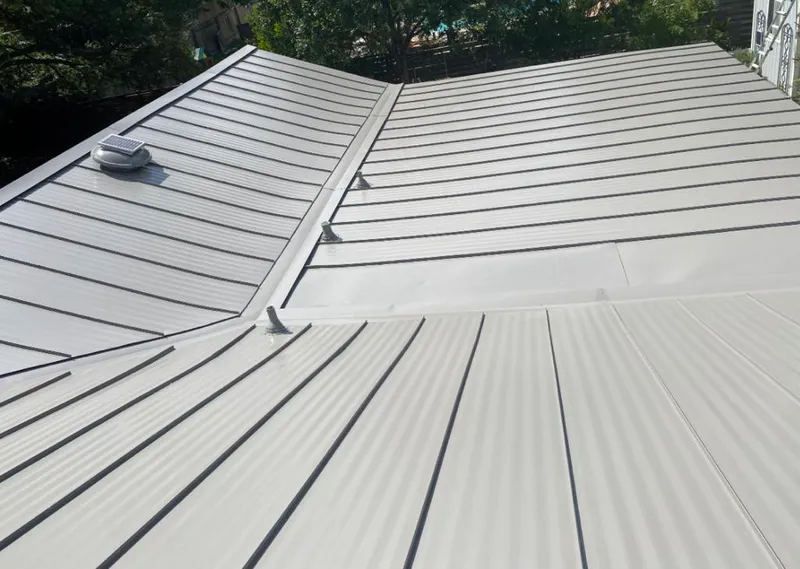 Solar attic fan installed on a metal roof for Roof Ventilation in Nitro